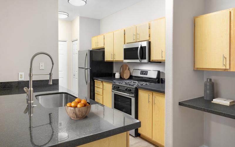 a kitchen with black appliances