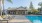 a swimming pool with a house in the background