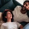 couple on the couch laughing