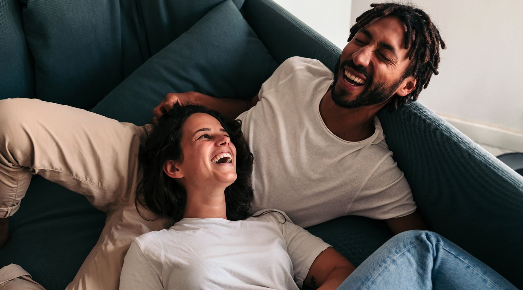 couple on the couch laughing
